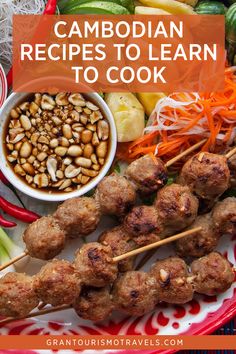 a plate with meatballs and vegetables on skewers next to some dipping sauce