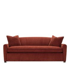 a red couch with two pillows on it's back and one arm facing the camera