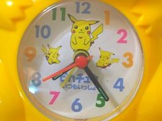 a close up of a clock with pikachu on it