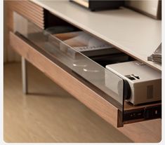 an electronic device is sitting on top of a shelf in a room with wood flooring