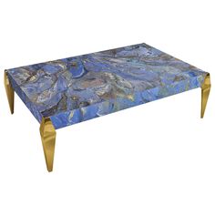 a blue and gold marble coffee table with brass legs on an isolated white background for display