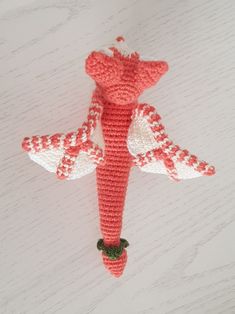 a crocheted red and white bird ornament