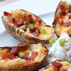 baked potatoes with bacon and sour cream on a white plate