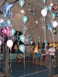 balloons and streamers are hanging from the ceiling