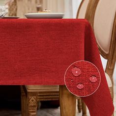 a red table cloth with hearts on it in front of a dining room table and chair