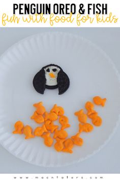 a paper plate with orange fish and a penguin made out of it's head