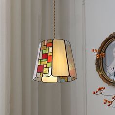 a lamp hanging from a ceiling next to a mirror