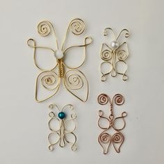 three butterfly brooches sitting on top of a table