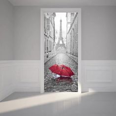 an open door with the eiffel tower and red umbrella in the rain outside