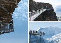 people are standing on the edge of a high cliff while others stand on a walkway above them