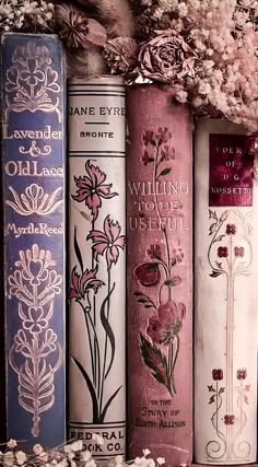 several books are lined up next to each other with flowers on the front and sides