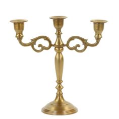 a golden metal candelabra with three candles