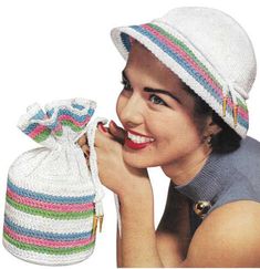 a woman wearing a hat and holding a knitted bag in front of her face