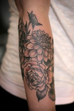 a woman's arm with flowers on it