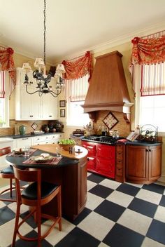 a kitchen with checkered flooring and an island in front of a stove top oven