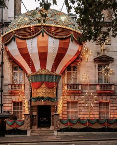 a large hot air balloon sitting in front of a building