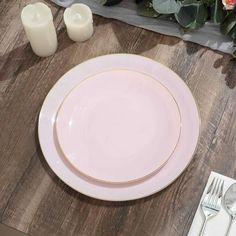 a white plate sitting on top of a wooden table next to a vase with flowers