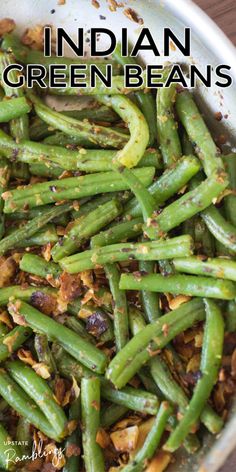 cooked green beans with coconut in a pan on a wooden table next to the words, sauteed green beans with coconut