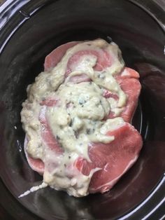 the meat in the slow cooker is covered with mayonnaise and seasoning