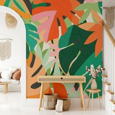 a living room with colorful wallpaper and white stairs leading up to the second floor