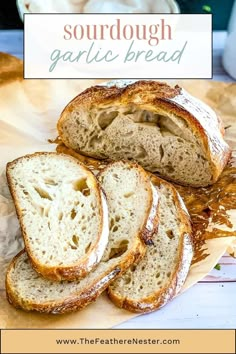 sourdough garlic bread cut in half on a cutting board with text overlay that says sourdough garlic bread