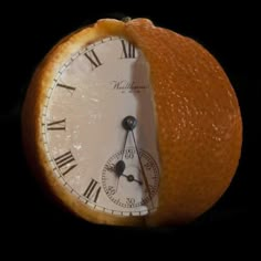 an orange with a clock face cut in half