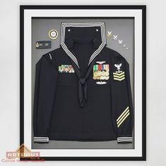 an uniform is displayed in a frame with the insignia on it and other items around it