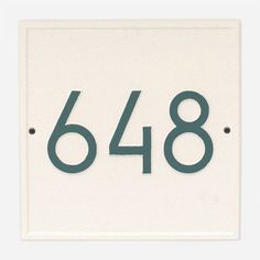 a white sign with the number six and four in it's center reads 648