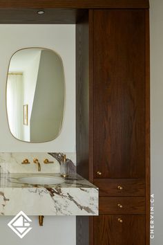 A dreamy master ensuite with a marble stone vanity and red oak towers on each side. Bathroom Retreat, Garbage Bin, Bronze Hardware, Oak Cabinets