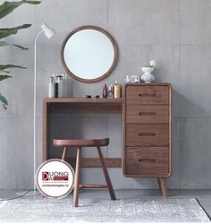 a wooden desk with a mirror and stool in front of it on a carpeted floor