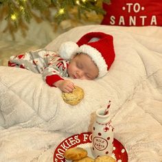 a baby is sleeping on a bed with cookies