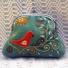 a green purse with a red bird on it