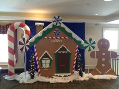 an indoor gingerbread house decorated with candy canes and snowflakes for the holiday season