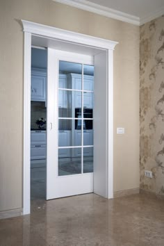 an empty room with glass doors and wallpaper