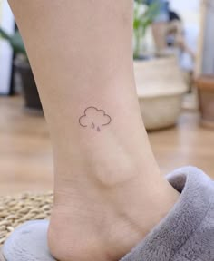 a small cloud tattoo on the ankle