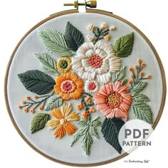 an embroidery pattern with flowers and leaves on it