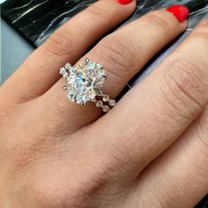 a woman's hand with a diamond ring on it