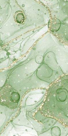 an image of some green and gold things in the water with bubbles on it's surface