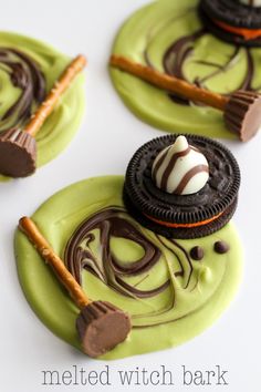 three cookies decorated with green icing and chocolate