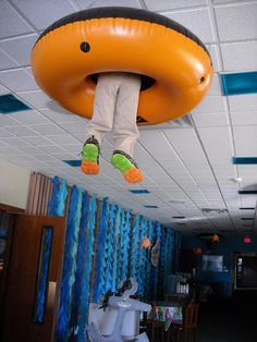 a person is hanging upside down on an inflatable object that hangs from the ceiling