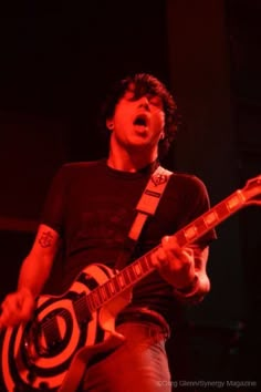 a man playing an electric guitar on stage