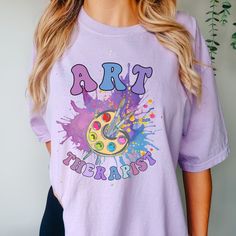 The comfortable fit and cool design of this art therapist shirt means that it feels just as good to wear as it is to look at. If you've been looking for a fun t-shirt for yourself, or your favorite art therapy friend, you should get this cute tee today.   This Comfort Colors t-shirt is made with 100% with ring-spun cotton. The soft-washed, garment-dyed fabric brings extra coziness to your wardrobe while the relaxed fit makes it an excellent daily choice. The double-needle stitching throughout the tee makes it highly durable while the lack of side-seams helps the shirt retain its tubular shape. .: 100% ring-spun cotton .: Medium fabric  .: Relaxed fit .: Sewn-in twill label   ✈ PROCESSING & SHIPPING ✈  Processing Time: 1-2 weeks   (usually 1-3 days) Standard Shipping: 2-5 business days afte Jennifer Ward, Art Therapist, Therapy Gift, Tshirt Art, Art Therapy, Tshirt Colors, Cool T Shirts, Comfort Colors, Comfort Fit