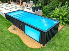 an above ground swimming pool in the middle of a yard with green grass and trees