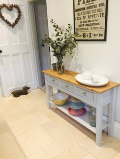 a kitchen island with two bowls on it and a potted plant next to it