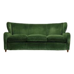 a green velvet sofa with wooden legs