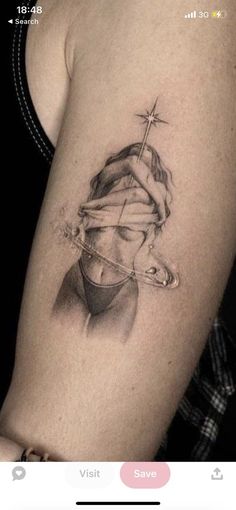 a woman's arm with a tattoo on it and a cross above her head