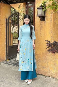 Ao dai women with pants Please check our size chart before placing your order. Colour: blue Material: embroidered organza fabric with Habotai silk lining  Collar: stand collar Layers: double layers Sleeves: 3/4 bell sleeves Fitting: loose fit Pants: indigo blue (dark blue) satin silk Standard delivery: Uk delivery: 2-5 days EU delivery: 7-10 days USA and other countries: 10-14 days Butterfly Embellishment, Flower And Butterfly, Vietnamese Traditional Dress, Festival Wedding, Traditional Dress, Women's Costumes