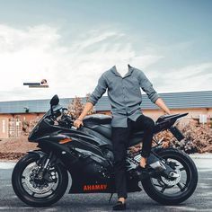 a man sitting on top of a black motorcycle