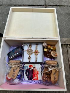 an open box filled with jewelry and personal items