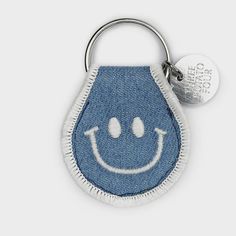 A fun natural cotton patch keychain with double-sided smiley face embroidery with metal split keyring. Measures 2.5" x 1.5". Patch Keychain, Felt Pennants, Fish Tanks, Keychain Design, Denim Patches, Vintage Objects, Boutique Design, Coin Pouch, Pack Of Cards